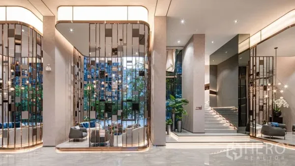 Condominium for sale in Ratchathewi, Bangkok - Elegant condominium lobby with mirrored partitions, plush seating, and warm feature lighting.