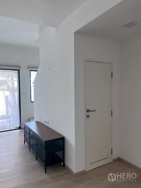 ทาวน์เฮาส์ ให้เช่าในBang Phli, Samut Prakan - โถงทางเข้า มีประตูสีขาวและตู้วางทีวีข้างบันได