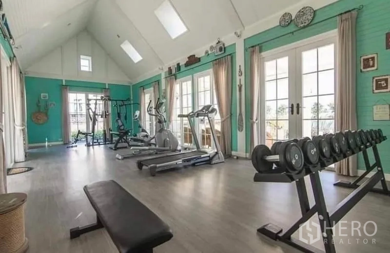 Detached House for rent in Bang Bo, Samut Prakan - Community fitness room with treadmills, free weights and a high vaulted ceiling.