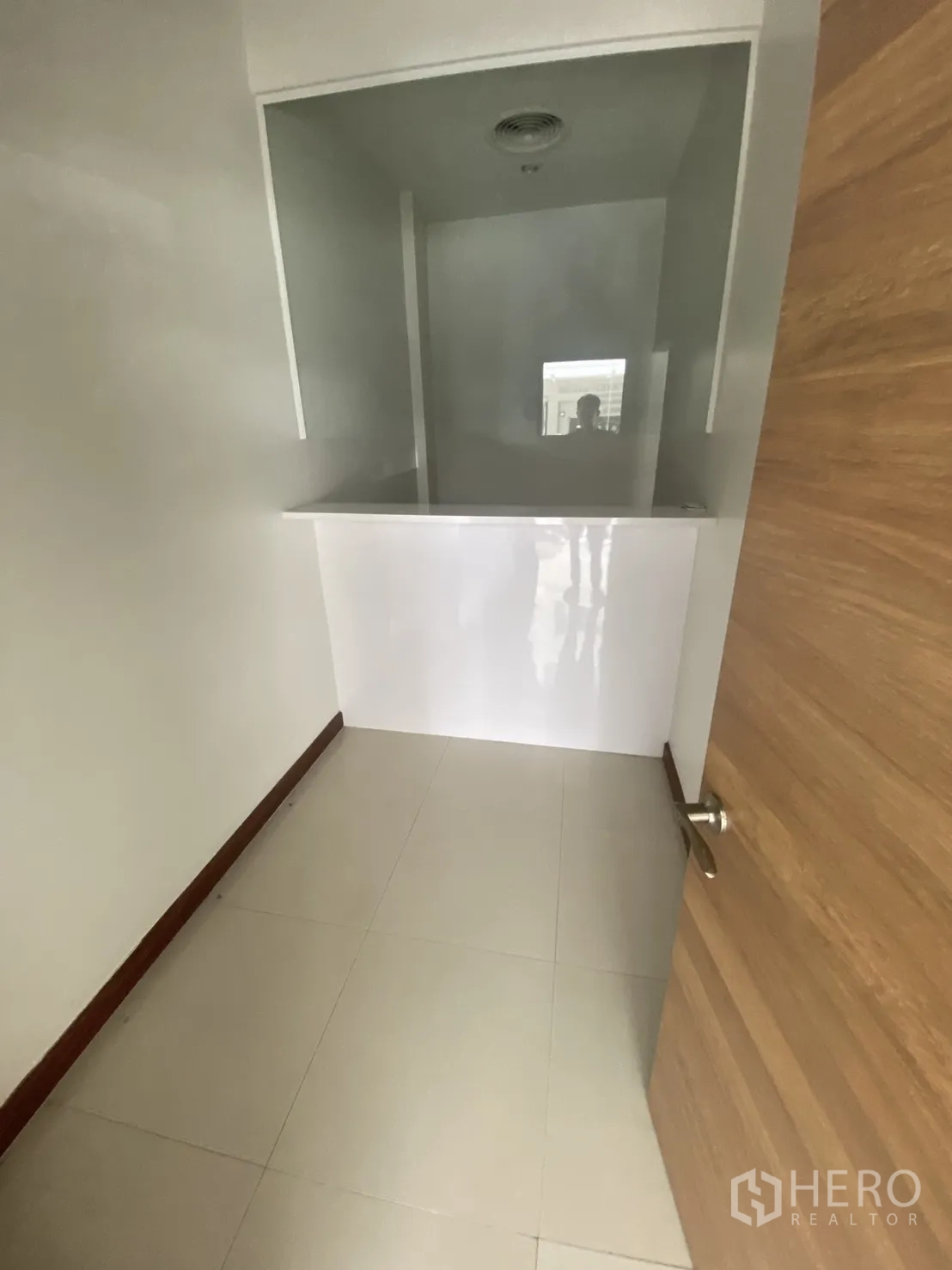Shophouse for rent in Bang Rak, Bangkok - Compact room with a half-height counter and interior window opening.