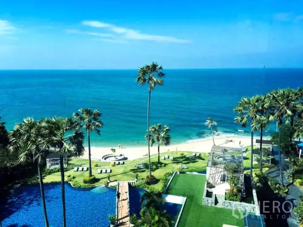 Condominium for rent in Bang Lamung, Chon Buri - Expansive view of the Gulf of Thailand with palm-lined beachfront gardens and a resort-style swimming pool.