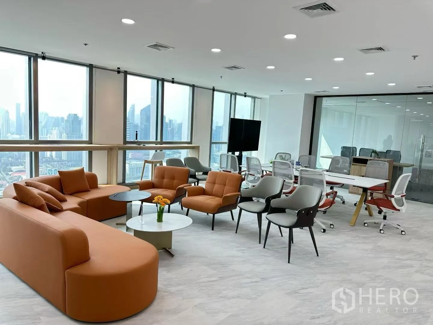 สำนักงาน for rent in Huai Khwang, Bangkok - เลานจ์และโซนประชุมสมัยใหม่ โซฟาสีส้ม โต๊ะประชุม และหน้าต่างพาโนรามา