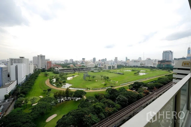 Condominium for rent in Pathum Wan, Bangkok - High-floor balcony view overlooking the Royal Bangkok Sports Club and BTS line.