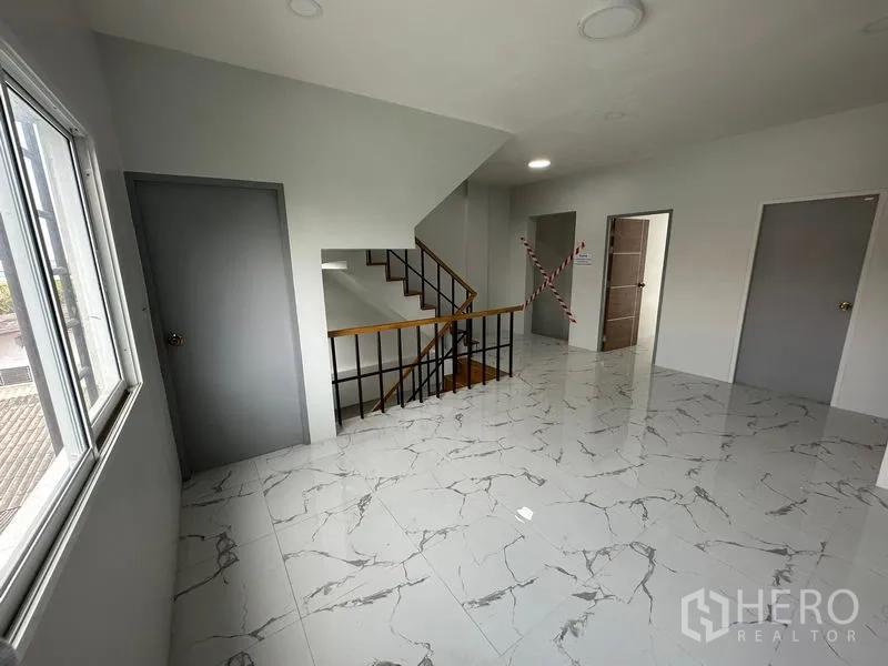 Home Office for rent or sale - Upper landing with wooden stairs, multiple doors and tiled floors suitable for meeting or breakout space.