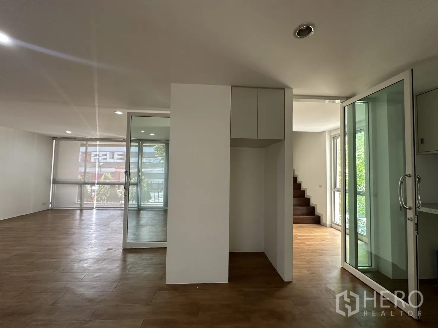Home Office for rent in Phra Khanong, Bangkok - Open space with sliding glass doors and a stairway to the upper level.