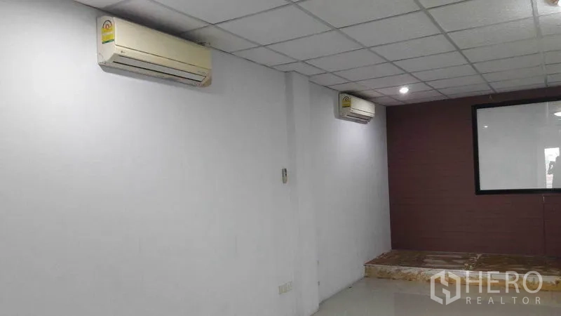 Office Space for rent in Bueng Kum, Bangkok - Open workspace with split AC units and a small raised platform.
