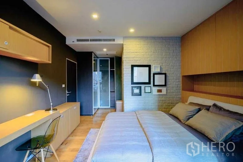 Condominium for rent in Watthana, Bangkok - Cozy bedroom with king bed, built‑in desk, and soft lighting.