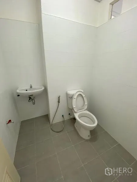 Office Space for rent in Chatuchak, Bangkok - Clean restroom with white tiles, toilet, handheld bidet and wall-mounted sink.