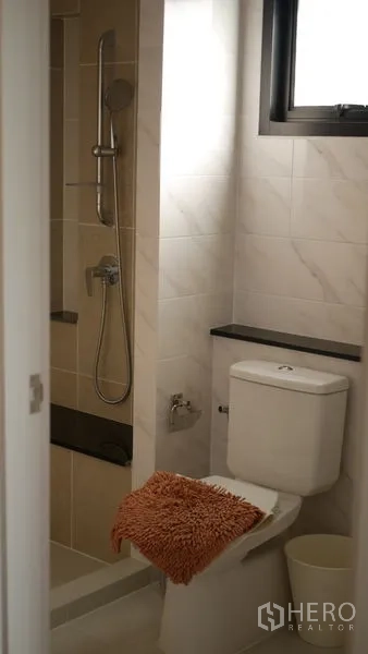 Detached House for rent or sale in Bang Bo, Samut Prakan - Bathroom with shower niche, handheld shower and window for ventilation.