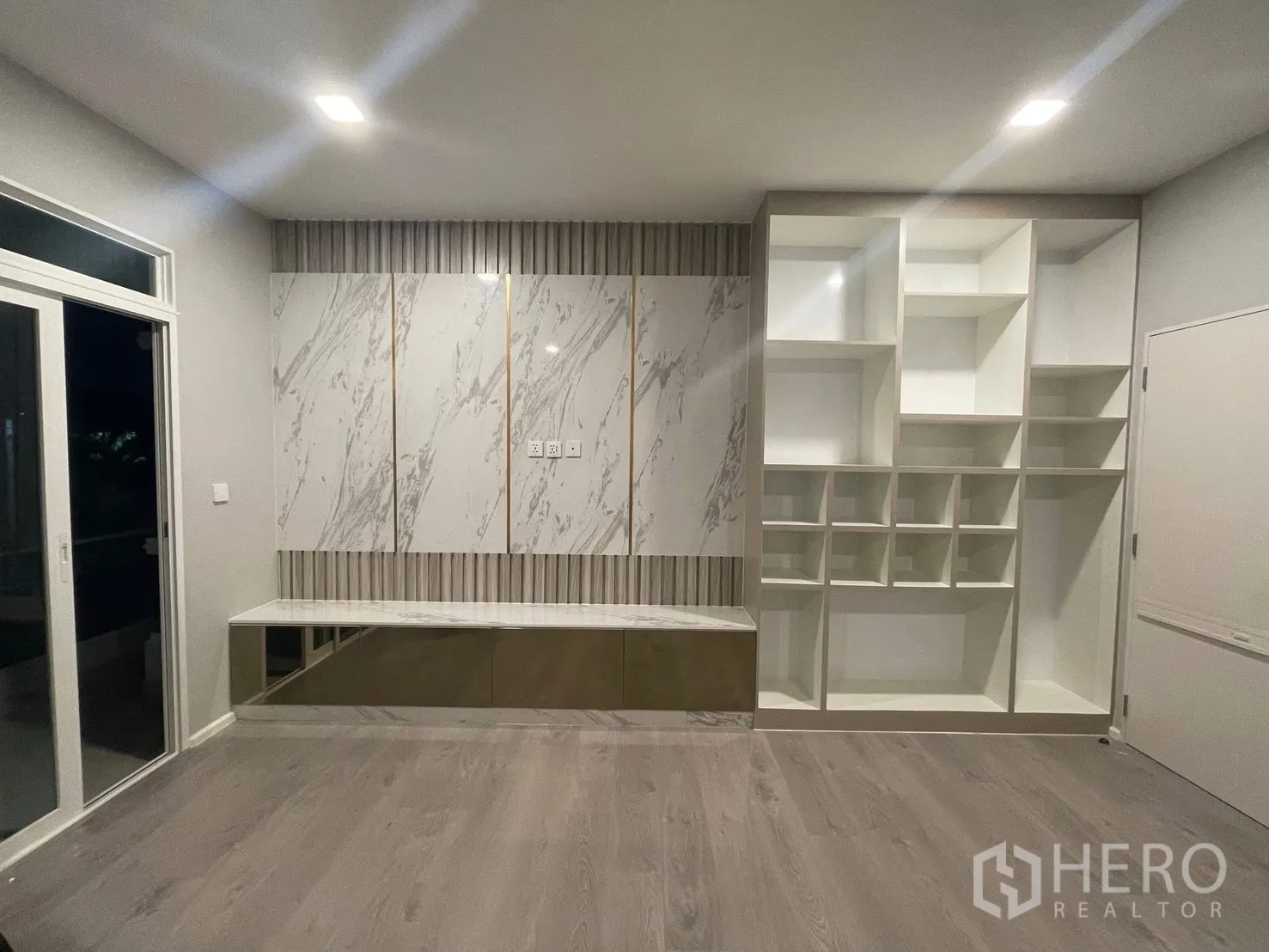 Detached House for rent in Prawet, Bangkok - Upstairs multipurpose room with marble feature wall and built-in shelving.