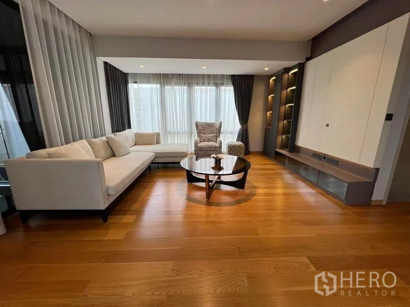 Detached House for sale in Suan Luang, Bangkok - Light-filled living area with sectional sofa, feature shelving and a media wall.