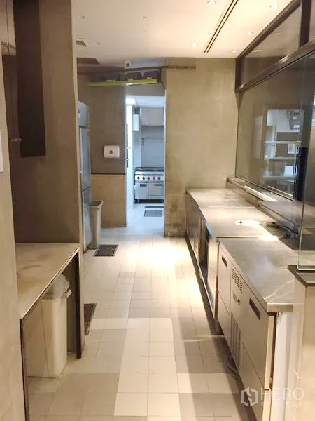 零售空间 出租在Khlong Toei, Bangkok - 商用厨房走道，配不锈钢操作台、冰箱与瓷砖地面