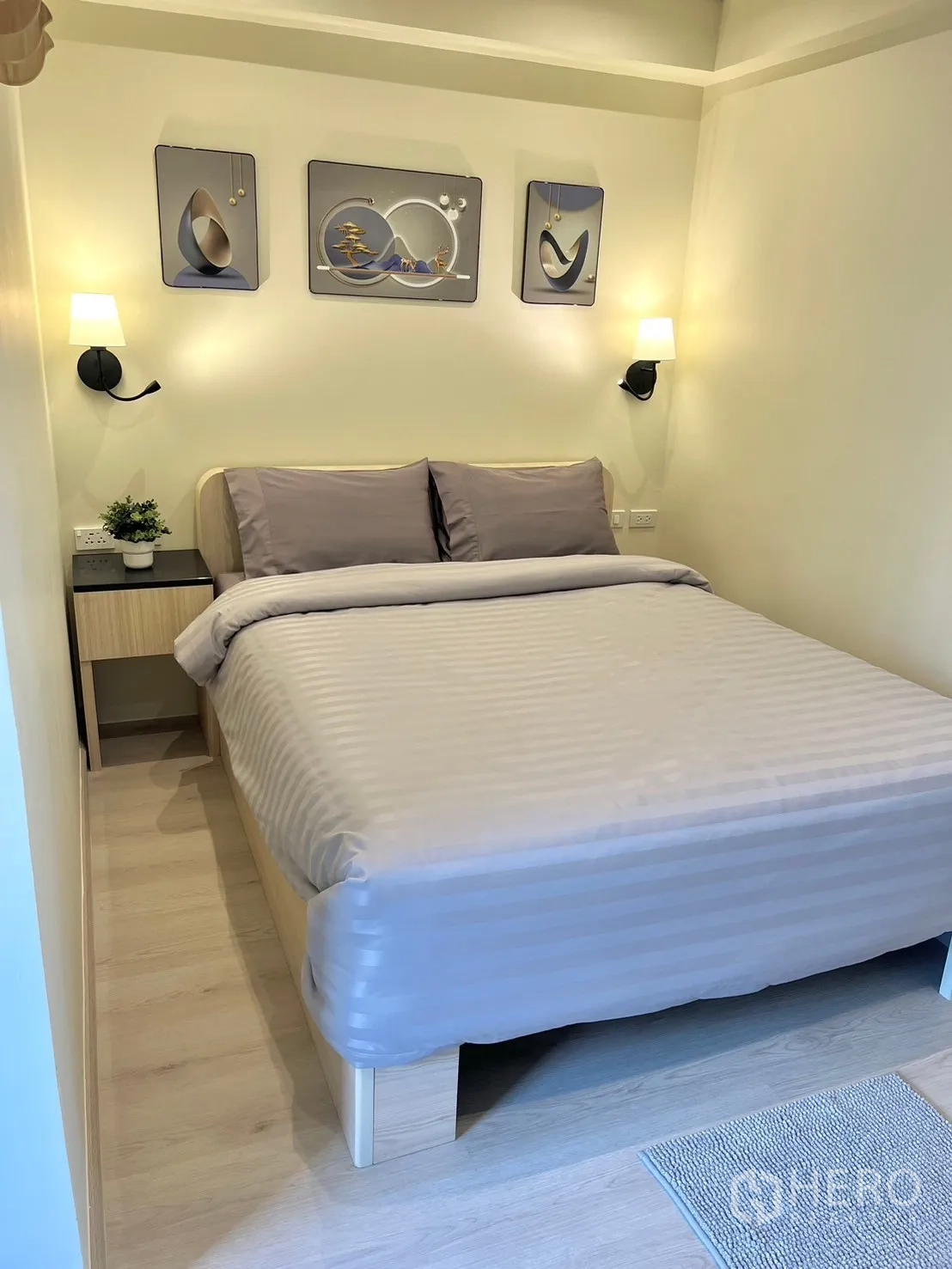 อาคารพาณิชย์ ให้เช่าในWatthana, Bangkok - ห้องนอนอบอุ่น ผ้าปูสีเทา โคมไฟติดผนัง และภาพตกแต่ง