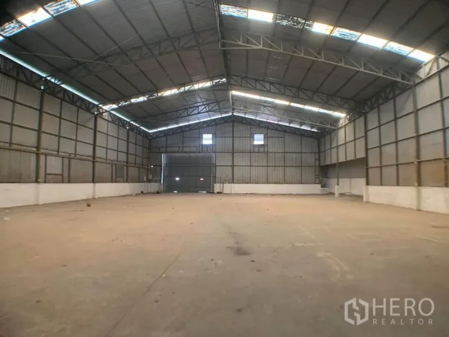 货栈 出租在Lak Si, Bangkok - 仓库内部宽敞，高挑钢结构，带天窗与大型卷帘门