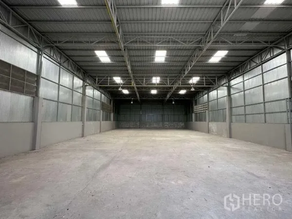 货栈 出租在Mueang Pathum Thani, Pathum Thani - 空旷的储存空间，金属墙体与明亮采光板，地面平整