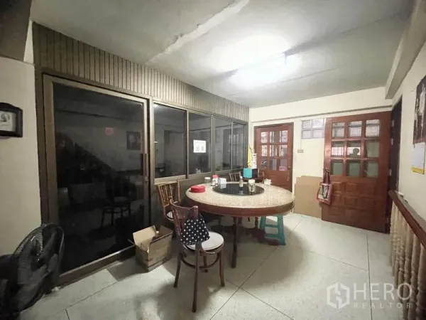 ทาวน์เฮาส์ ให้เช่าในSathon, Bangkok - มุมรับประทานอาหาร โต๊ะกลม ฉากกั้นกระจก และประตูไม้ในทาวน์เฮ้าส์สาทร