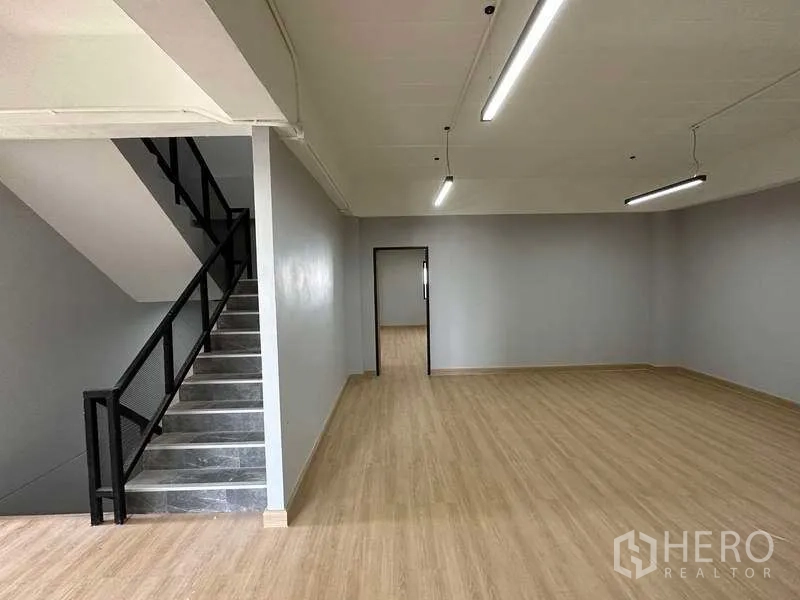 Factory for sale in Khlong Luang, Pathum Thani - Upper-floor office space with wood-look flooring and metal stairway.