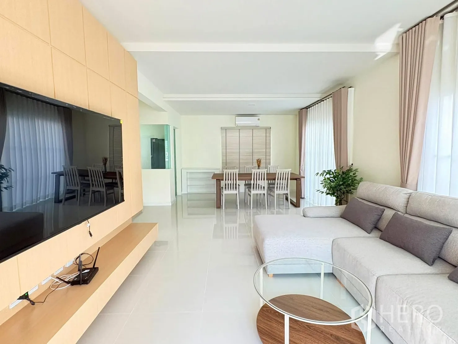 独立式住宅 for rent in Bang Phli, Samut Prakan - 宽景客厅望向餐厅，大窗与室内绿植相映。