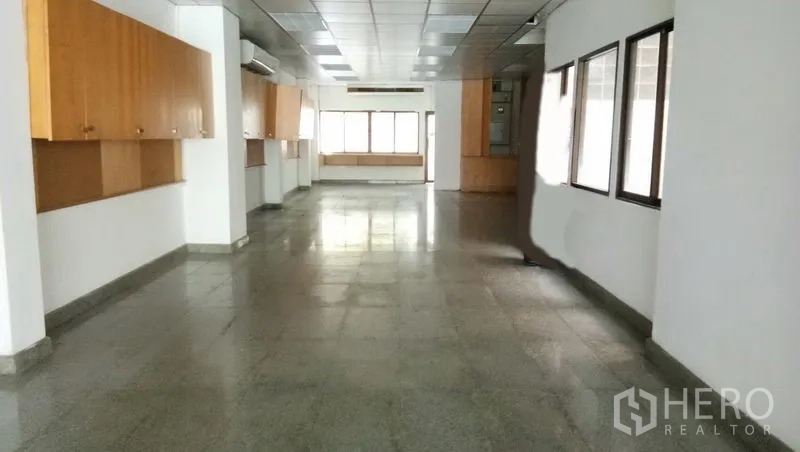 Office Space for rent in Sathon, Bangkok - Large office floor with multiple windows, wall cabinets, and air-conditioning units.
