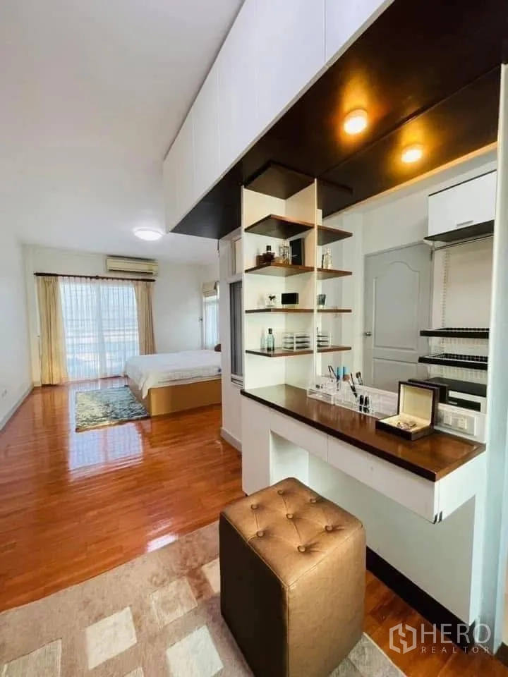 独立式住宅 出租或出售在Lam Luk Ka, Pathum Thani - 主卧木地板，带内置梳妆台与开放式置物架。