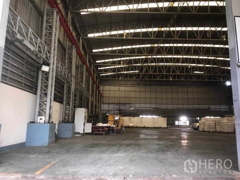 Factory for rent in Bang Phli, Samut Prakan - Clear-span warehouse interior featuring high clearance, steel beams and wide loading area.