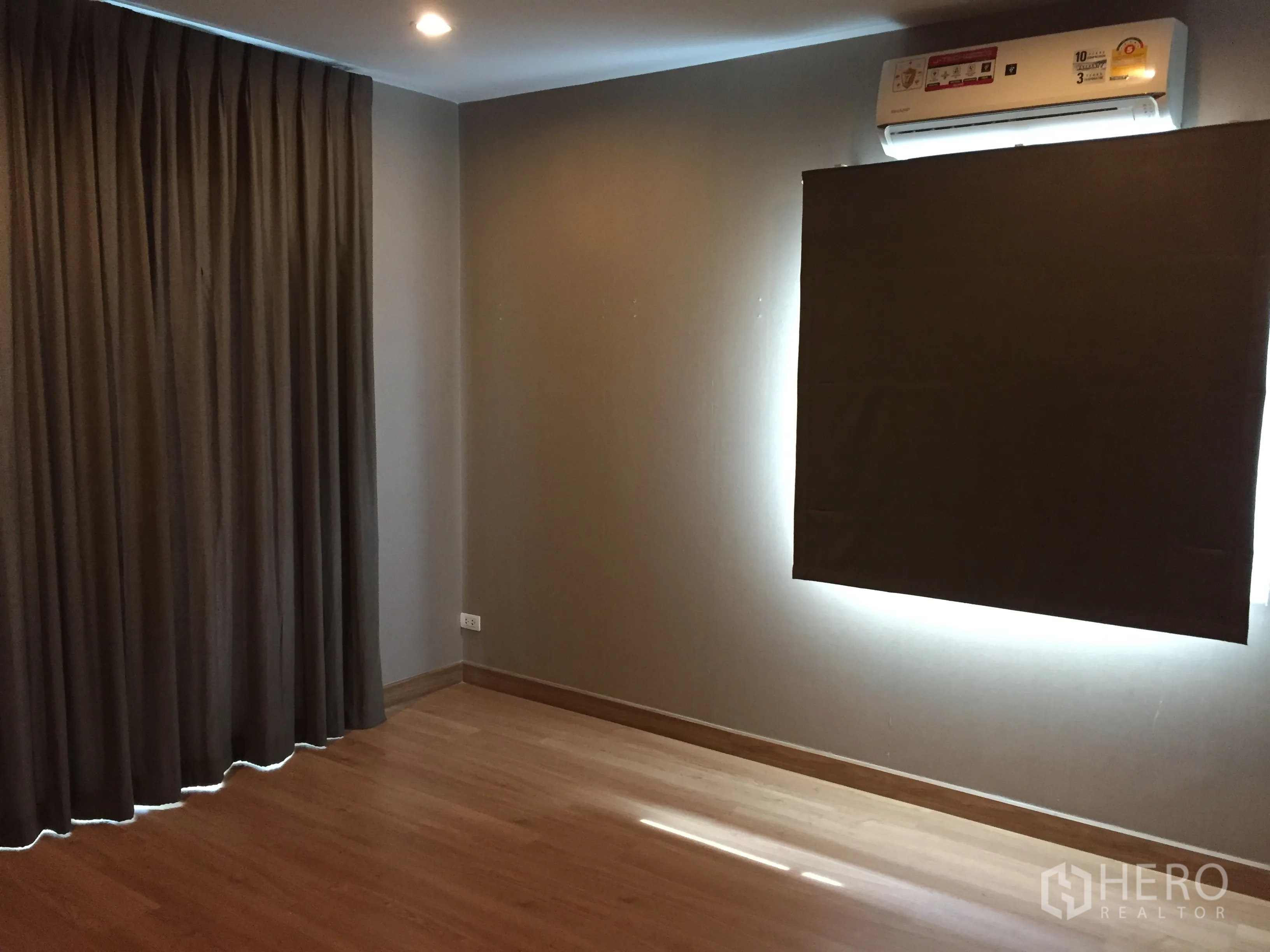 Detached House for rent in Pathum Thani - Secondary bedroom with wood flooring, blackout curtains and air conditioning.