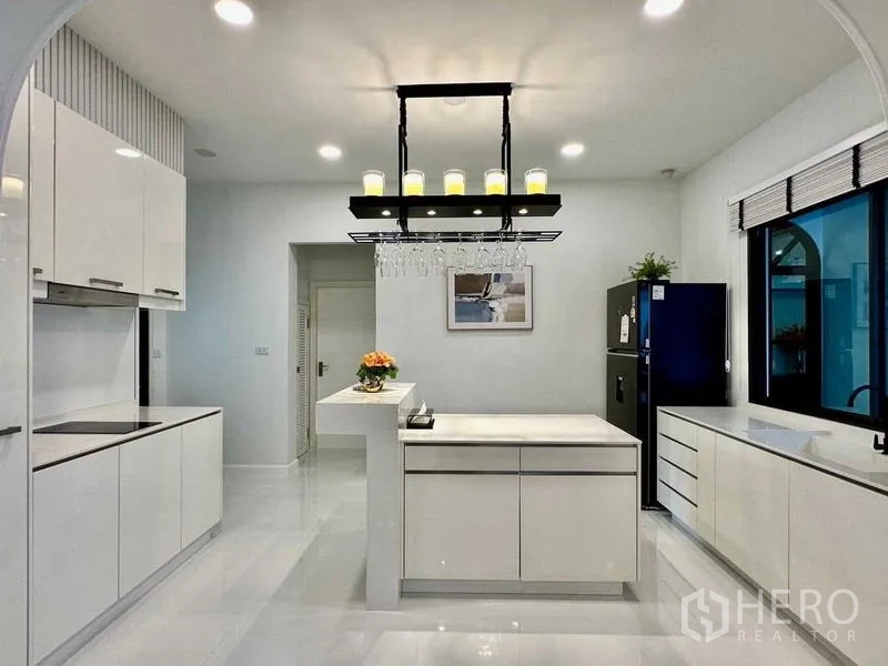 Detached House for rent in Bang Phli, Samut Prakan - Modern white kitchen with island and pendant lighting.