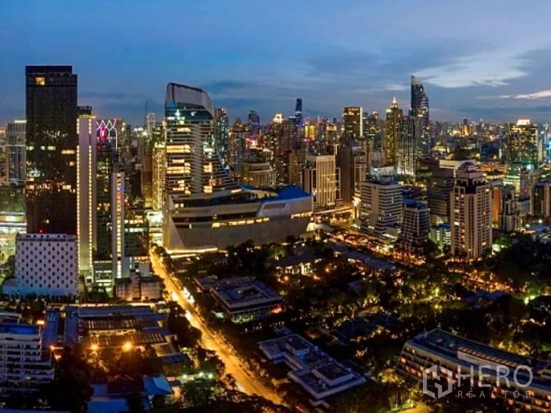 Condominium for rent or sale in Pathum Wan, Bangkok - Night view of central Bangkok skyline with illuminated high-rises and city lights.