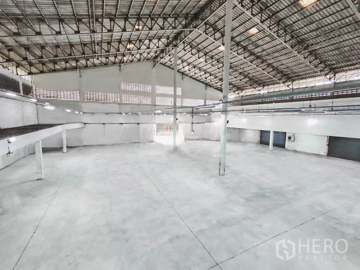 工厂 出售在Samut Prakan - 开放式生产大厅，带夹层平台、通风砖墙与多处装卸门。