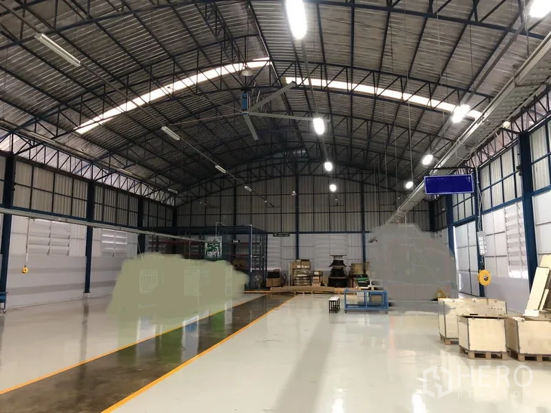 Factory for sale in Pathum Thani - Open warehouse with ventilation panels and overhead service rails for workflow.