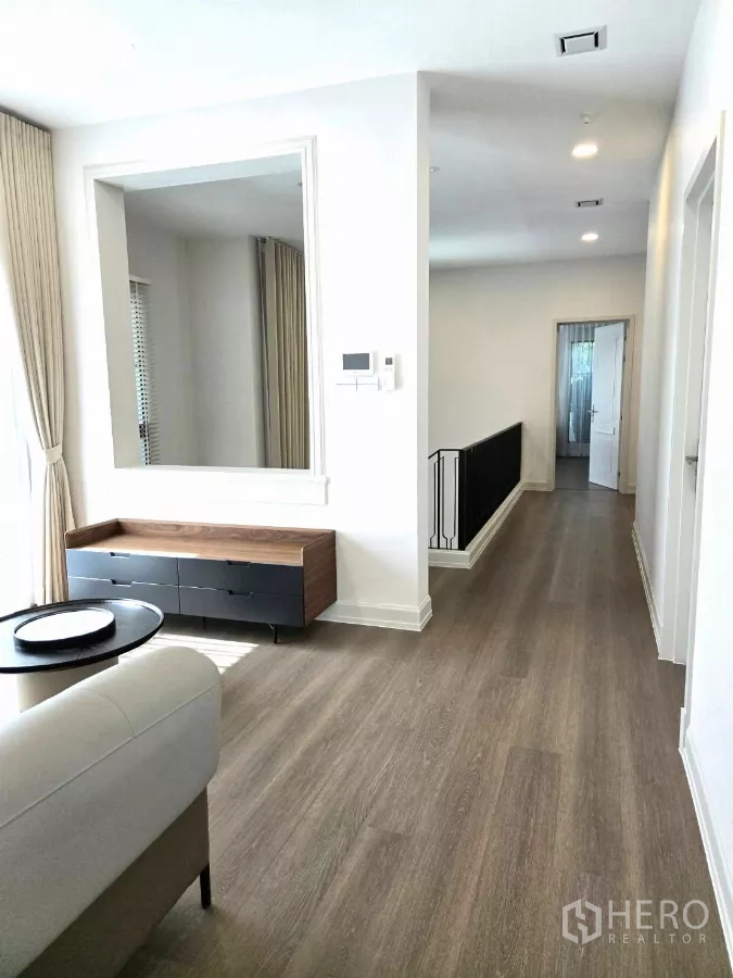 Detached House for rent in Saphan Sung, Bangkok - Upper lounge with console cabinet, mirror and natural light.