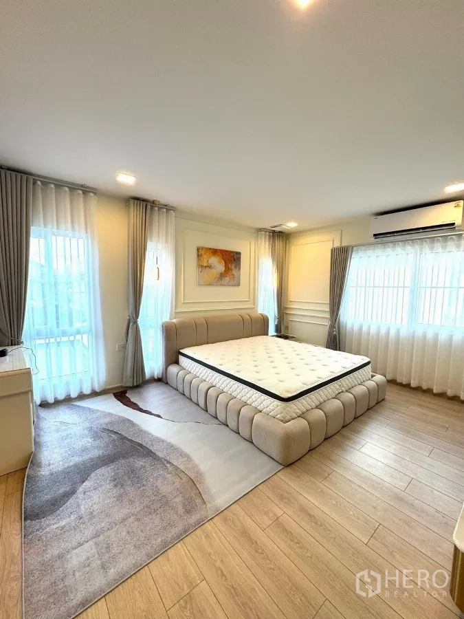 Detached House for rent in Bang Phli, Samut Prakan - Master bedroom showing king bed, big windows and airy curtains.