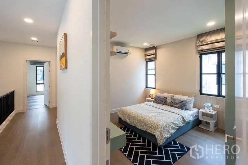 Detached House for sale in Saphan Sung, Bangkok - Upstairs hallway opening to cozy bedroom with natural light.
