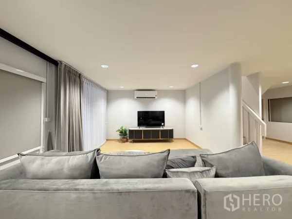 Detached House for rent - Living area facing TV console with air conditioner and floor-to-ceiling curtains.