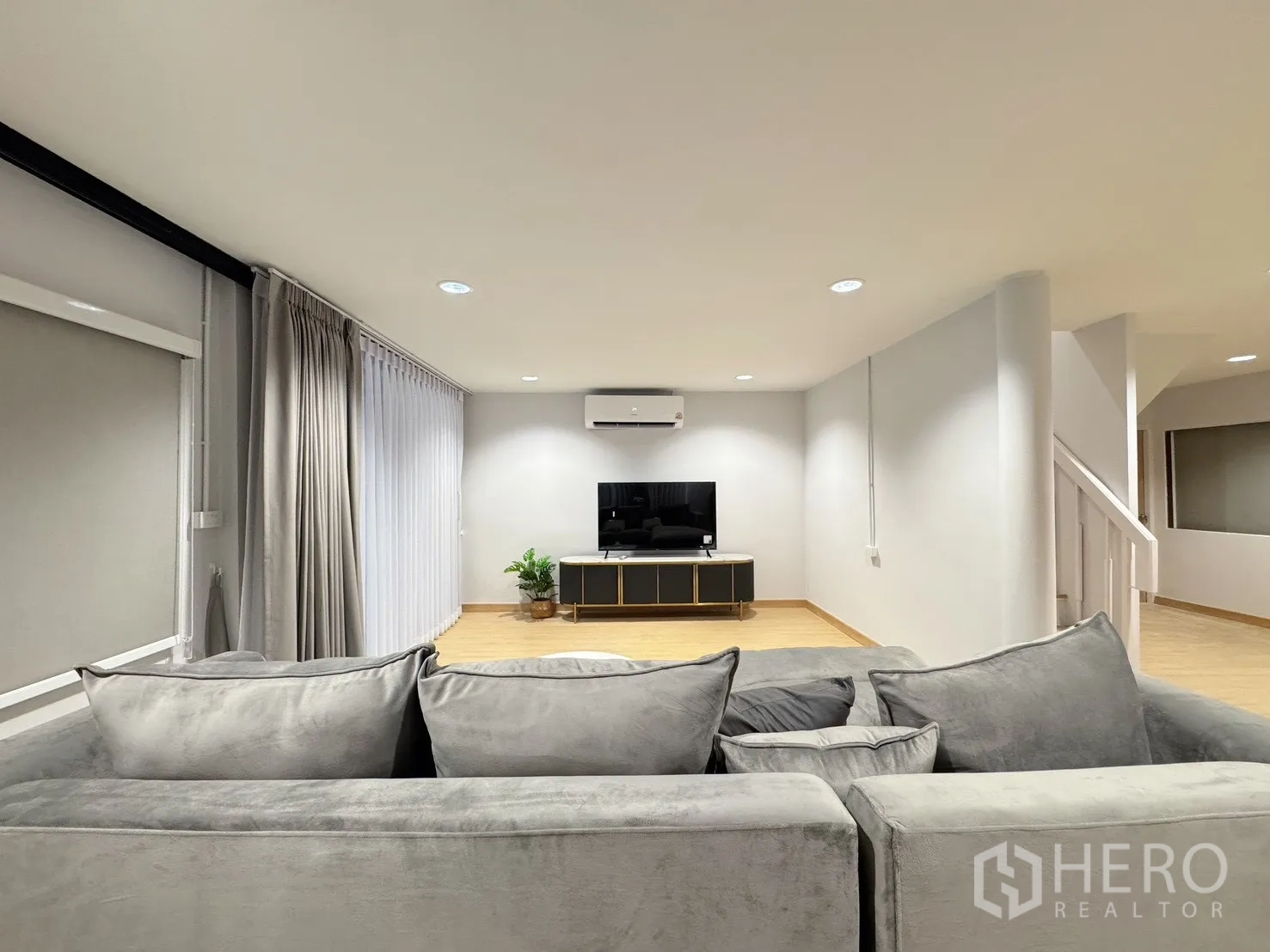 Detached House for rent - Living area facing TV console with air conditioner and floor-to-ceiling curtains.