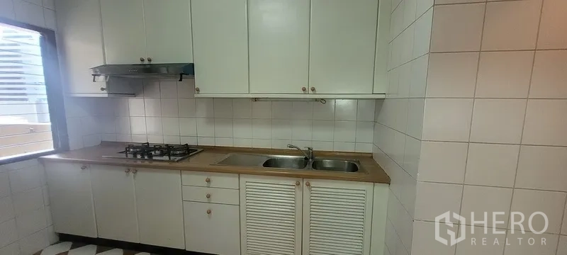 คอนโด ให้เช่าในWatthana, Bangkok - ครัวปิดตู้สีขาว เตาแก๊ส เครื่องดูดควัน และอ่างล้างจานคู่