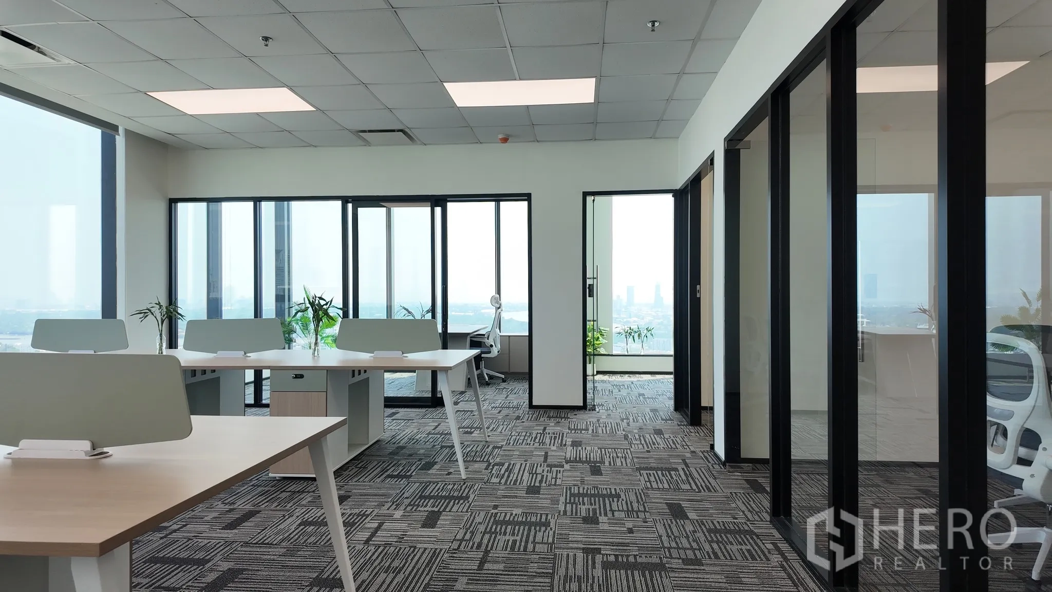 Office Space for rent in Khlong Toei, Bangkok - Spacious workstation area with city views and access to private glass offices.