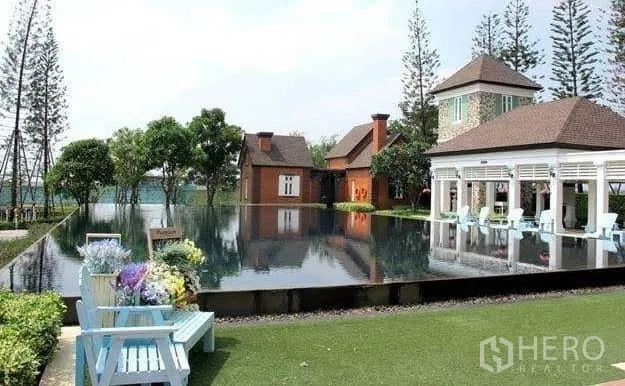 Detached House for sale in Samut Prakan - Lakeside clubhouse with reflective infinity pool, seating and landscaped gardens.