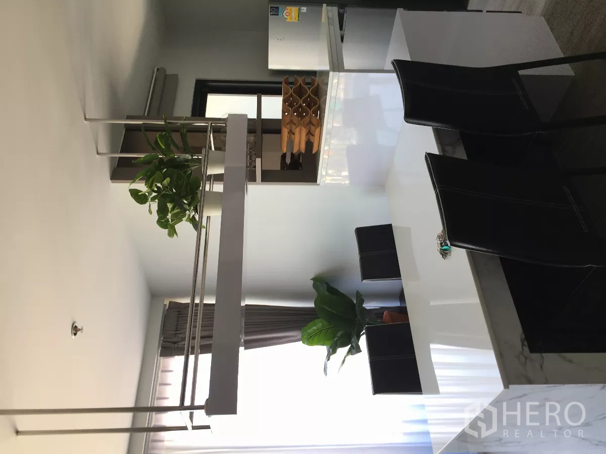 Condominium for rent or sale in Watthana, Bangkok - Dining counter with hanging shelf and potted plants next to the kitchen.