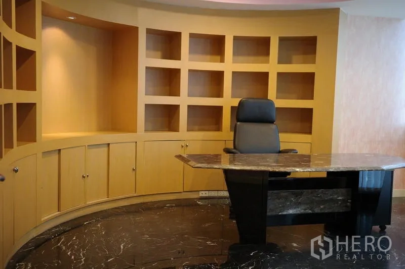 Office Space for rent in Bang Na, Bangkok - Executive suite featuring a marble-top manager desk and curved built-in shelves.
