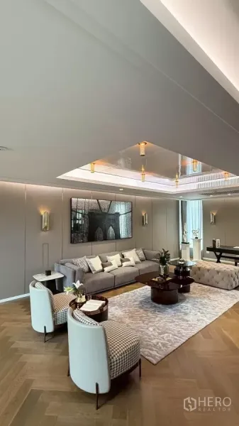 Detached House for sale in Saphan Sung, Bangkok - Elegant living area with herringbone wood floor, recessed ceiling and contemporary furniture.