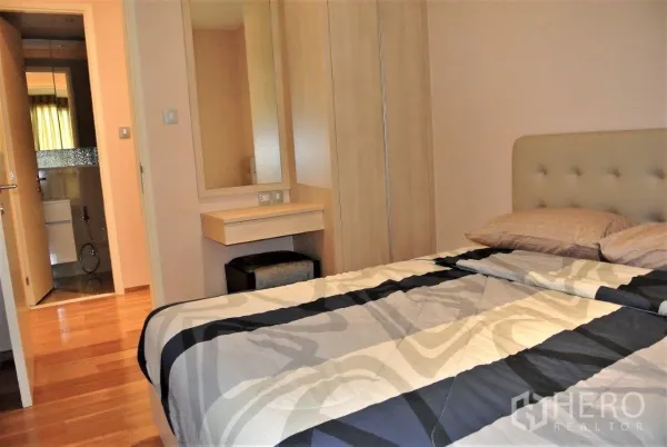 คอนโด ให้เช่าในWatthana, Bangkok - ห้องนอนอบอุ่น มีตู้เสื้อผ้าบิลท์อิน โต๊ะเครื่องแป้ง และทางเข้าห้องน้ำ พื้นไม้และแสงไฟนุ่มนวล