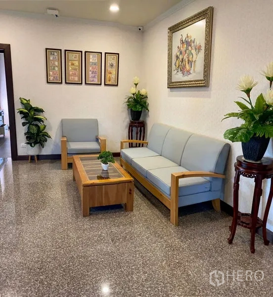 Detached House for sale in Bang Bo, Samut Prakan - Cozy sitting area with sofa set, coffee table, indoor plants, and framed art.