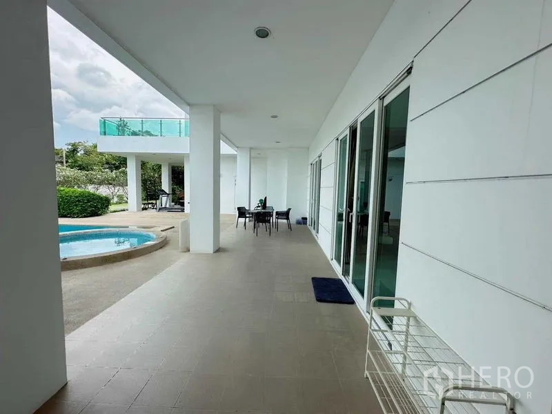 Detached House for rent or sale in Bang Phli, Samut Prakan - Covered walkway with sliding glass doors opening to pool and spa