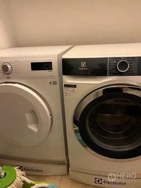 Condominium for rent in Pathum Wan, Bangkok - Laundry area featuring Electrolux front‑load washer and matching dryer.