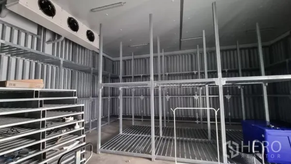 Warehouse for rent in Phra Samut Chedi, Samut Prakan - Interior of -18°C cold room with metal shelving and ceiling evaporator fans.