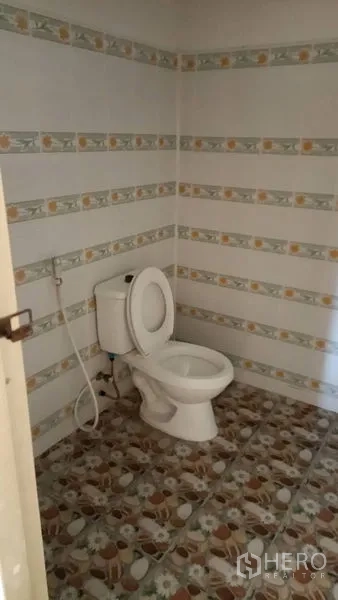 Retail Space for sale in Lam Luk Ka, Pathum Thani - Clean restroom with toilet, handheld bidet and patterned tiles.