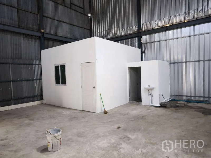 Warehouse for rent in Krathum Baen, Samut Sakhon - Small internal white office with restroom and sink inside the warehouse.