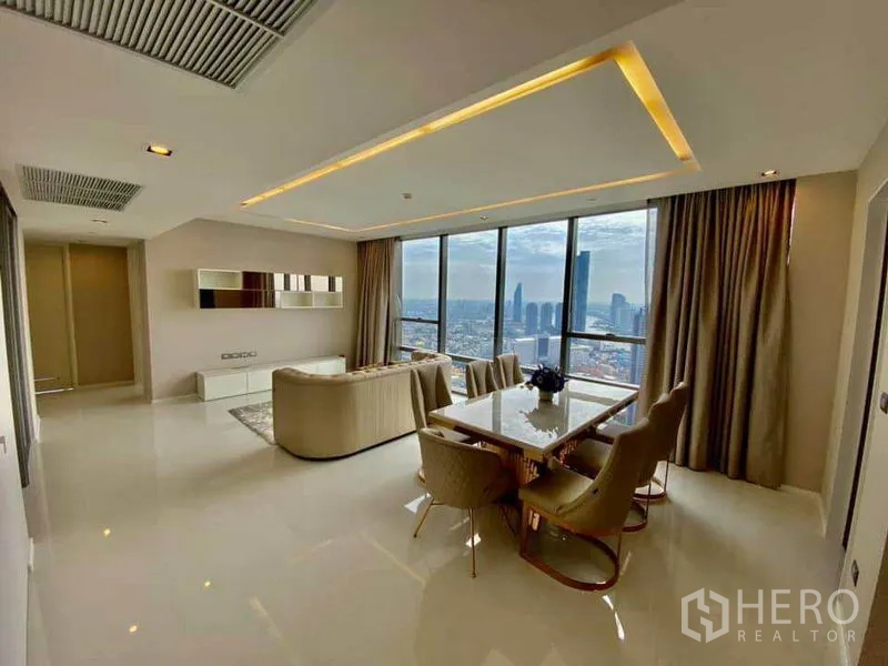 Condominium for rent in Sathon, Bangkok - Open-plan living and dining room with large windows and a panoramic city skyline.