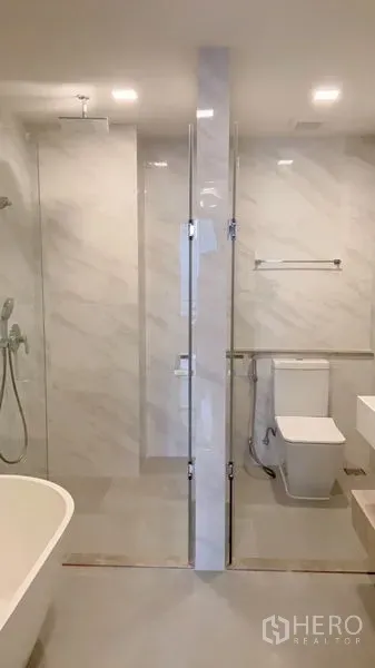 公寓 出租在Watthana, Bangkok - 宽敞卫浴配步入式淋浴、坐便与台盆，玻璃隔断相连浴缸。